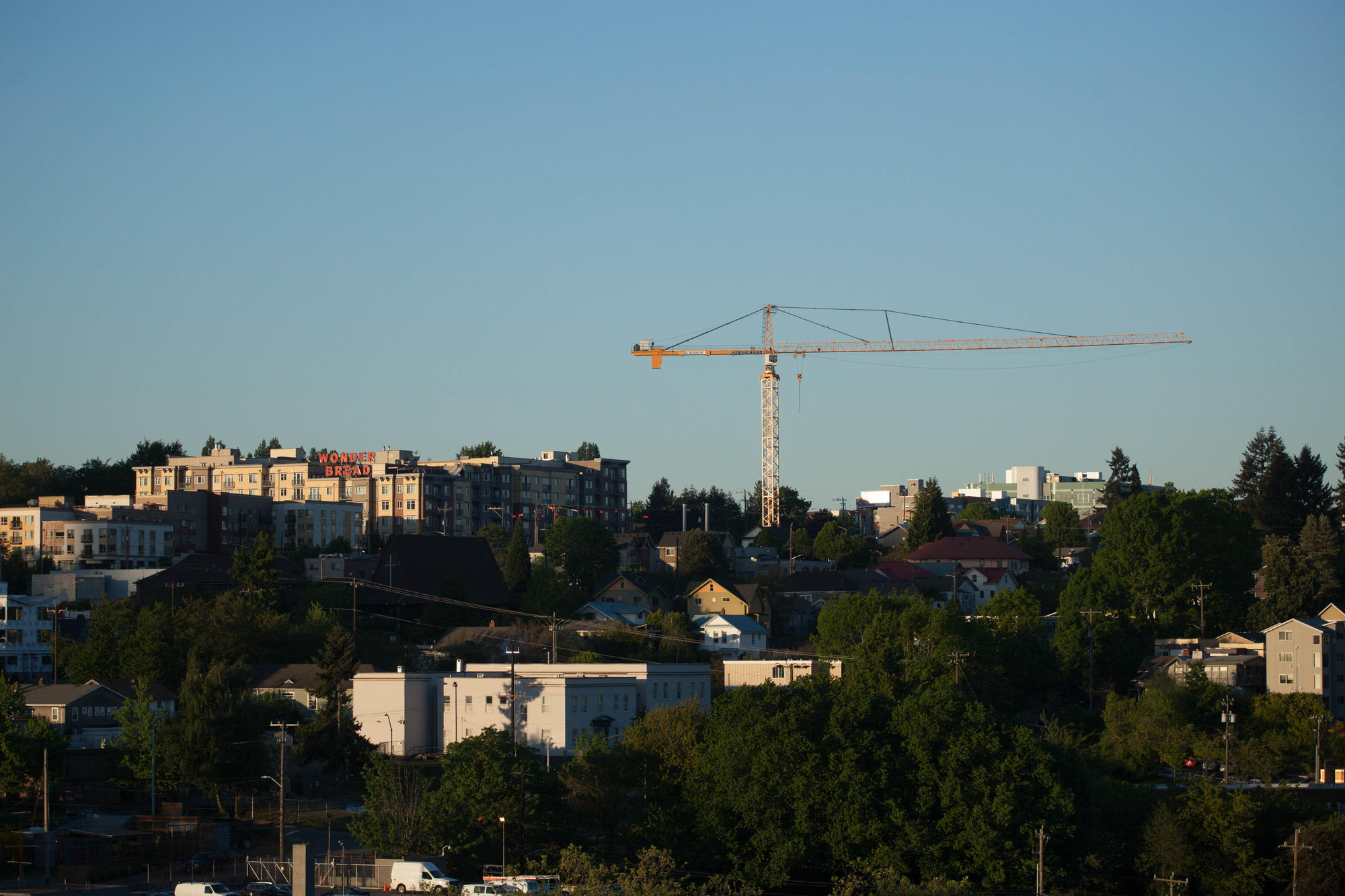 a construction crane looms over a Seattle neighborhood