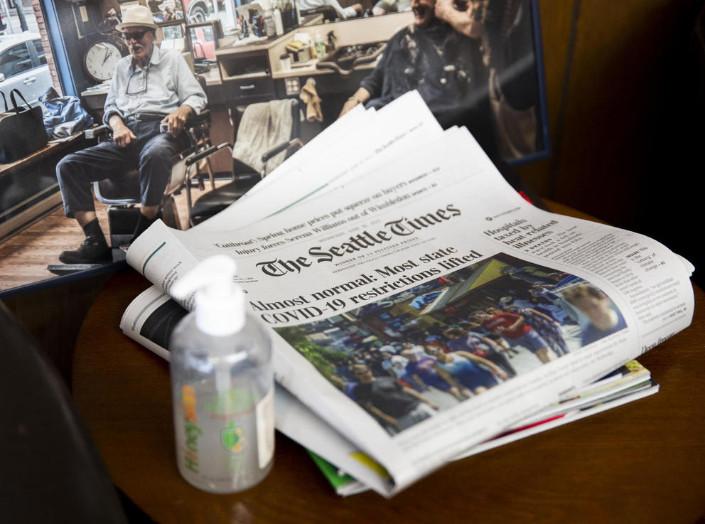 Hand sanitizer and a newspaper