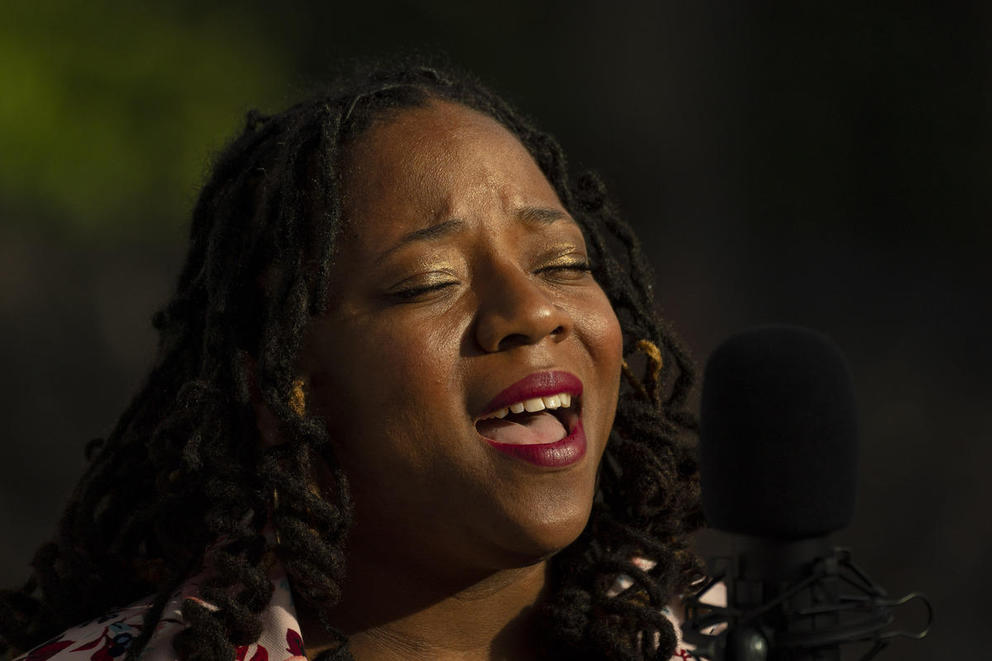 A close up of L. Patrice Bell's face as she sings
