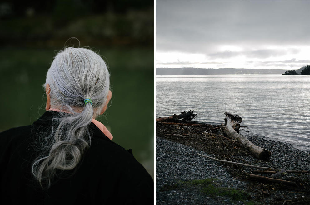 On the left, Larry Campbell is seen from behind, his gray hair pulled back into a low pony tail. On the right, driftwood lies on the bank of Skagit Bay under an overcast sky