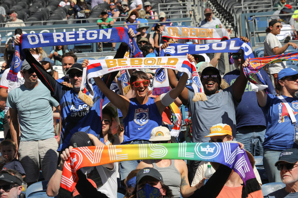 Fans holding up team scarves