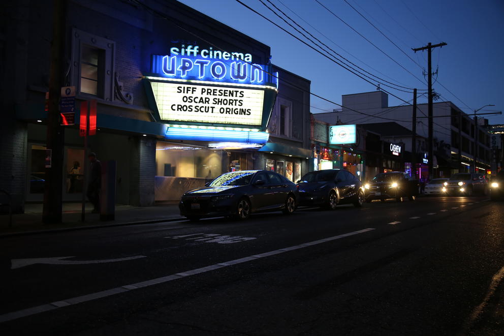 The marquee of SIFF Uptown Theatre light up with the Crosscut Origins title. 