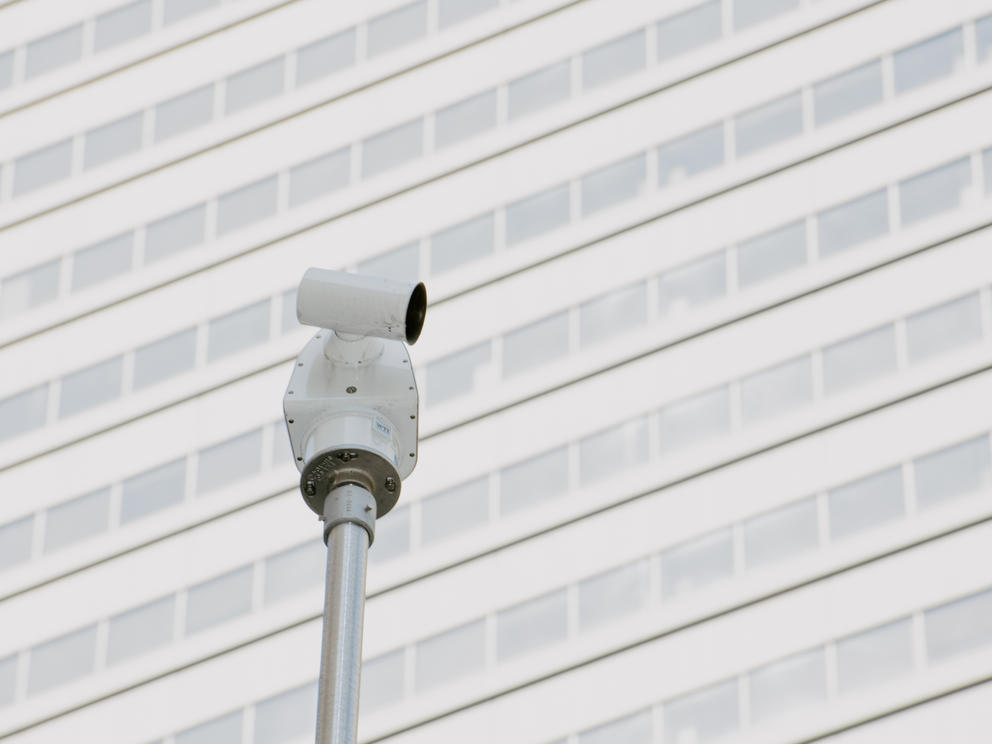 A single traffic camera stands in front of a building in downtown Seattle