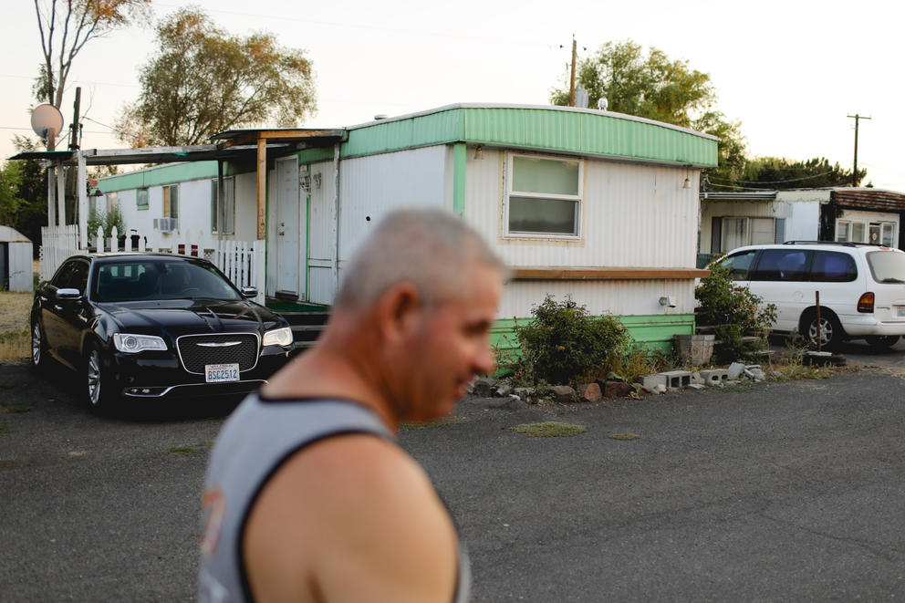 Guillermo Limon walks through White Dove mobile home park