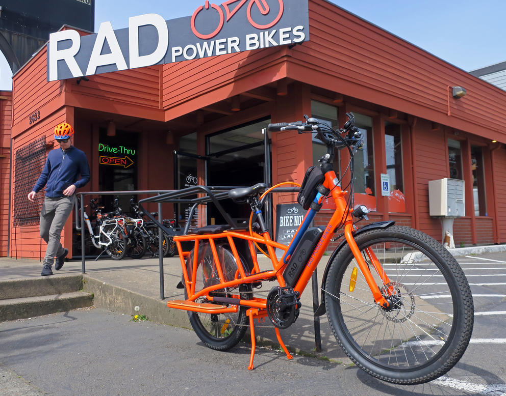 An e-bike is parked infront of a Rad Power Bikes showroom in Seattle.