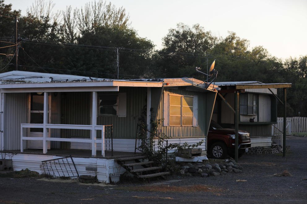 The evening sun shines on mobile homes in Sun Tides mobile home park