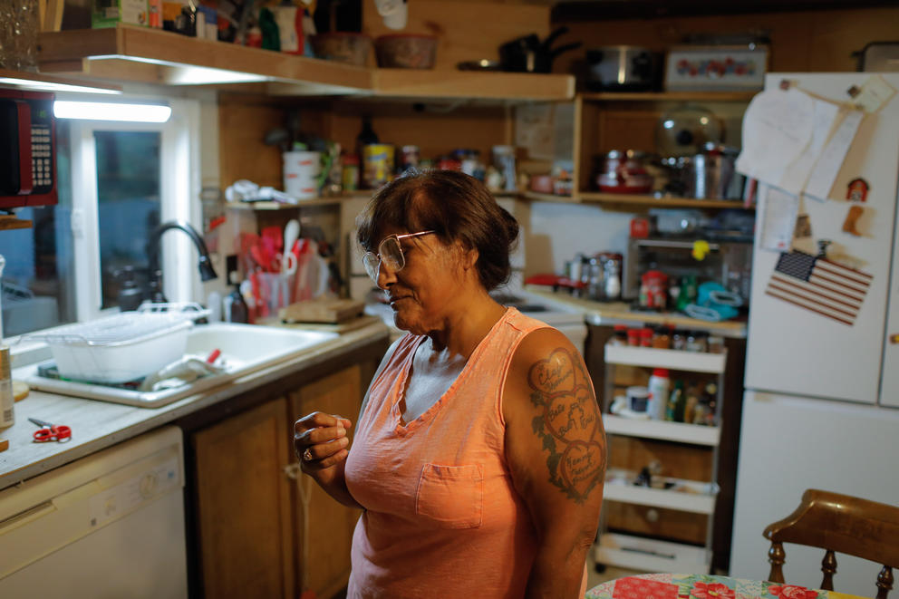 A portrait of Elva Simmons in the kitchen of her mobile home