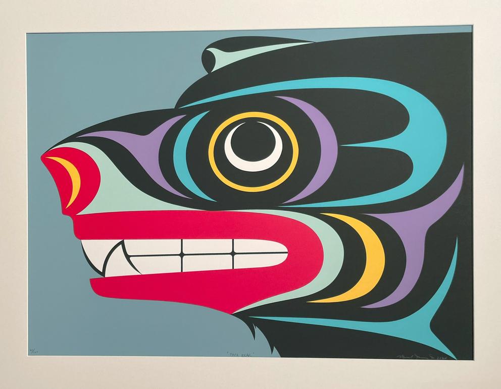 a red, black and light blue painting of a bear's head in the formline tradition