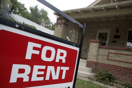 A "for rent" sign appears outside a property