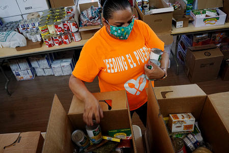 Volunteer fills boxes with food