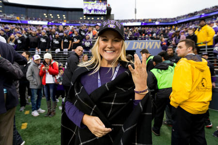 University of Washington Athletic Director Jennifer Cohen flashes a “W” sign at Husky Stadium