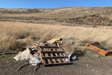 A wood pallet and other trash along a road in Kennewick, Washington.
