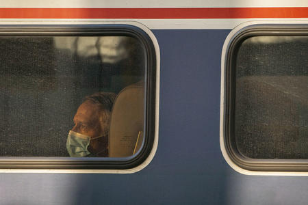 Passenger looks out the window of an Amtrak train