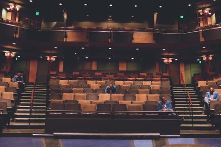 Reginald André Jackson sits in an empty theatre. 