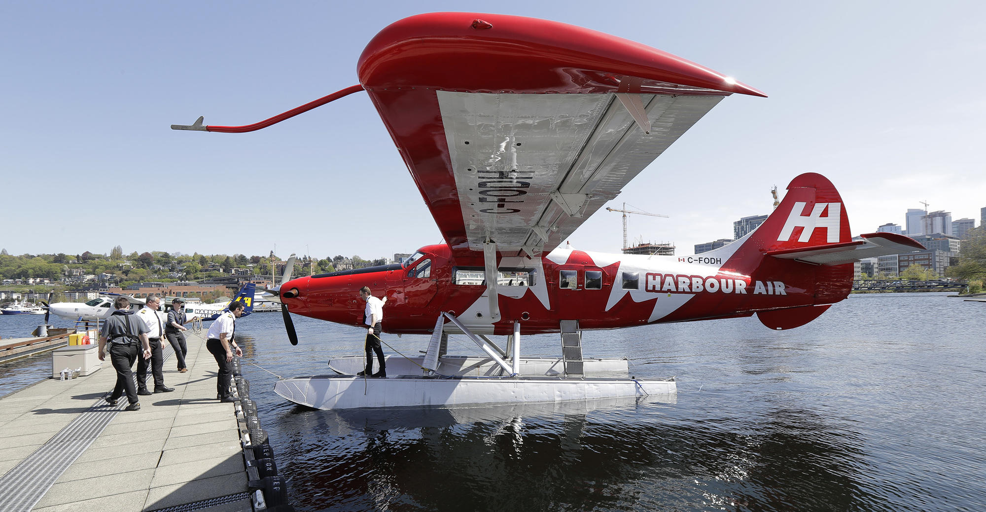 A Harbour Air seaplane is docked Wednesday, April 25, 2018, on Lake Union in Seattle. A partnership between Harbour Air and Kenmore Air will start offering direct one-hour seaplane flights between downtown Seattle and Vancouver, BC. (AP Photo/Ted S. Warren)
