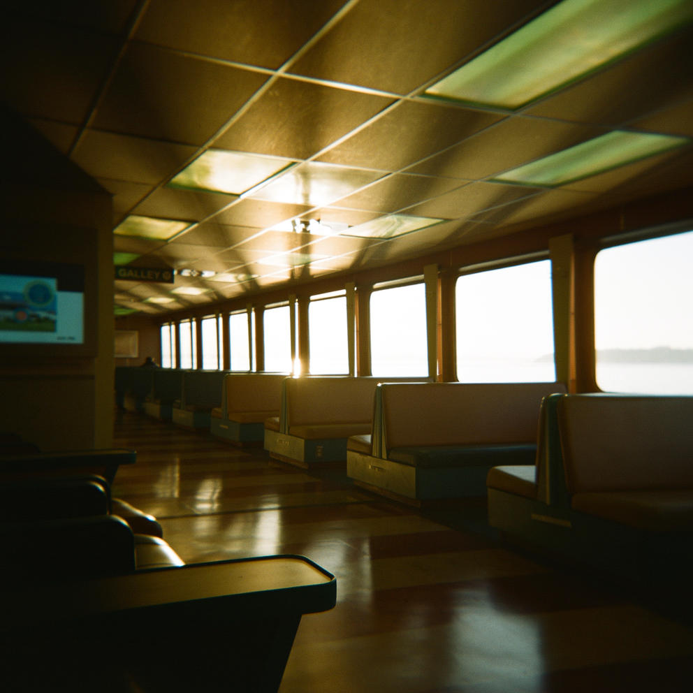 Sunlight shines in through the windows of an empty ferry boat