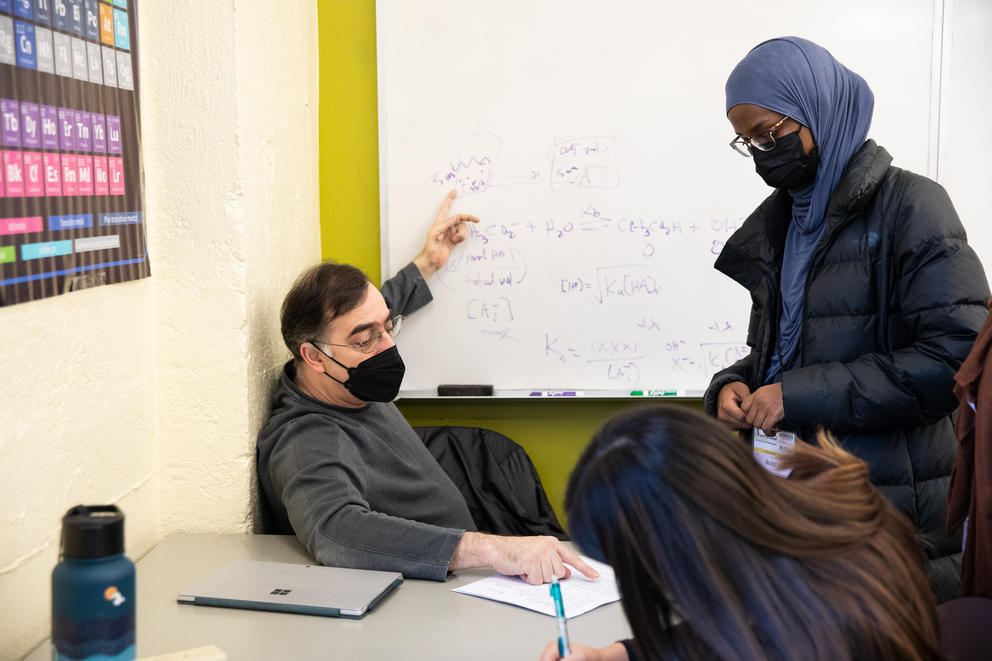 Instructor Scott Clary offers students support on their Chemistry homework