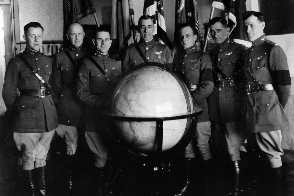 The entire team in uniform pose around a large glob.