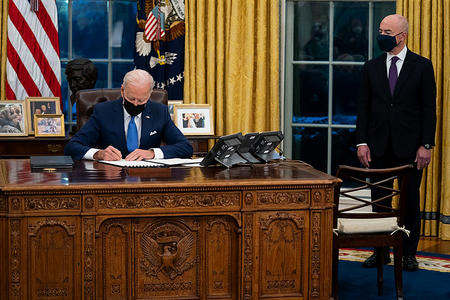 Biden writing at his desk