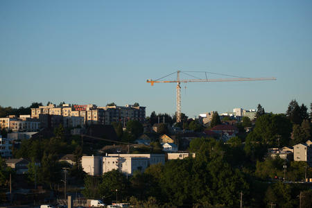 houses and a construction crane fill the skyline. 