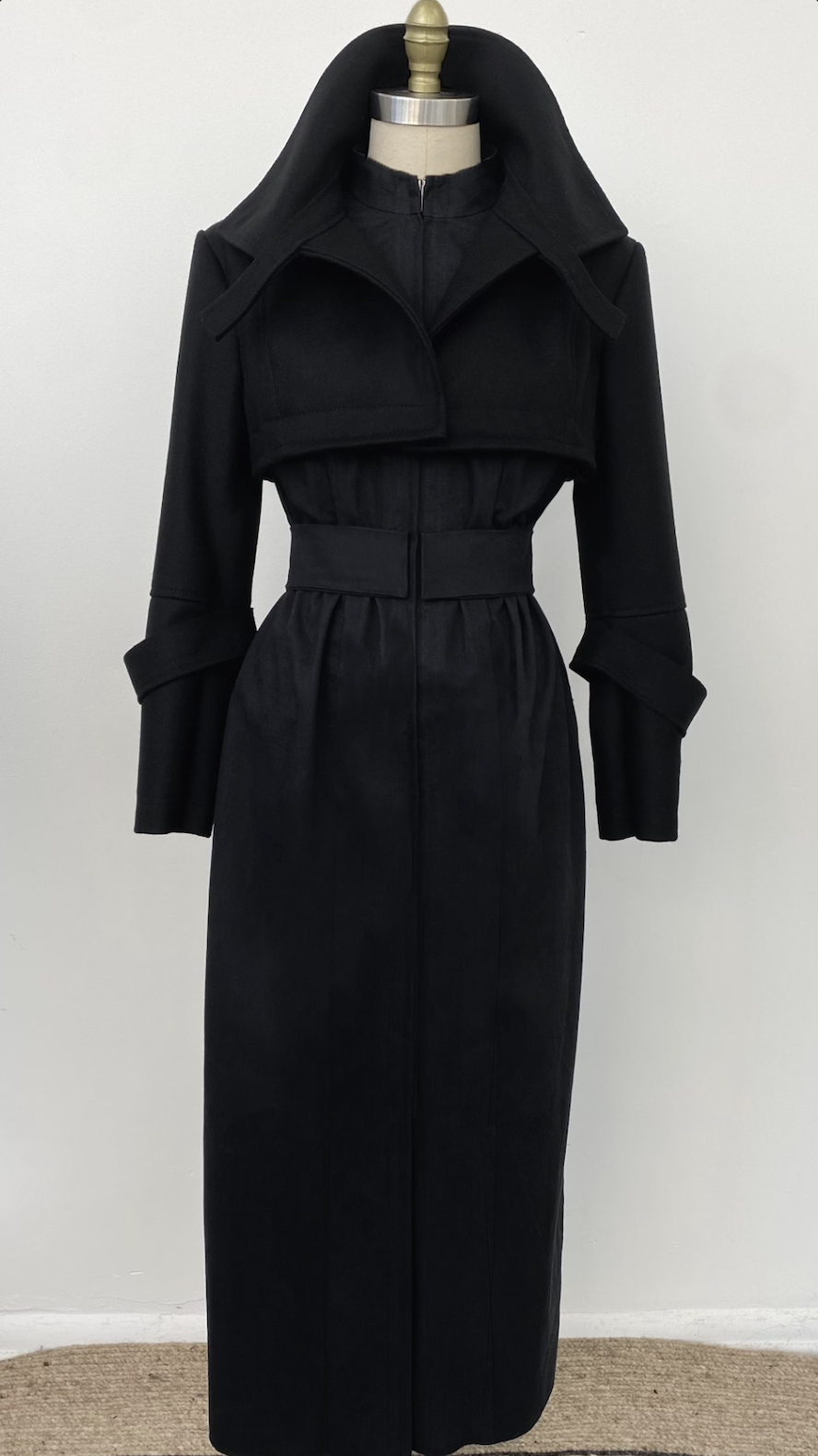 A black trench coat with a high collar